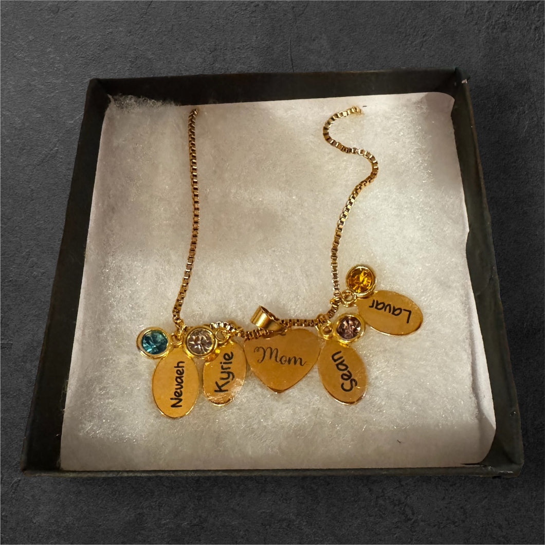 Personalized birthstone necklace with engravings of kids' names on mom's heart.